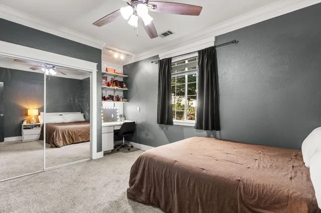 a view of a hallway with closet and wooden floor