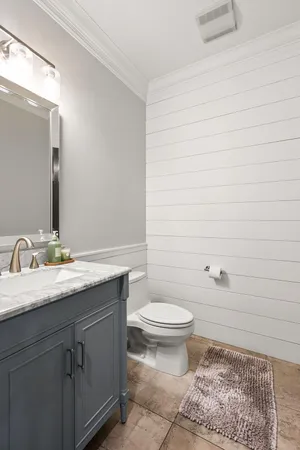 a patio with table and chairs and potted plants