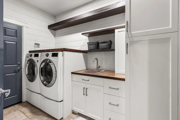a view of a patio with table and chairs and potted plants