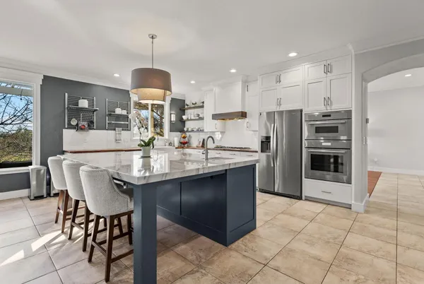 a dining area with a table chairs and a kitchen view