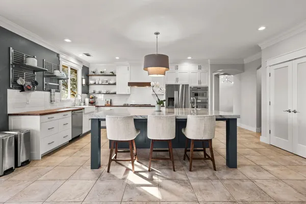 a kitchen with a stove a sink and a window
