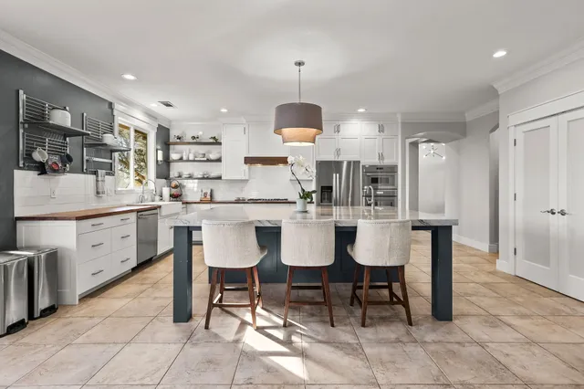 a kitchen with a stove a sink and a window