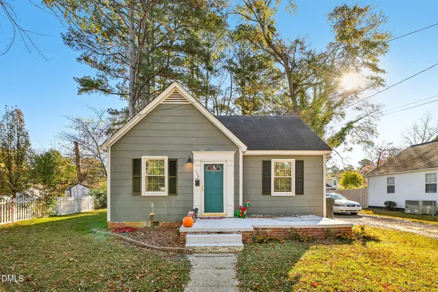 a front view of a house with a yard outdoor seating and garage
