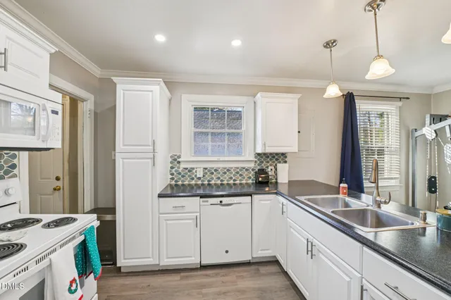 a kitchen with a sink stove and cabinets
