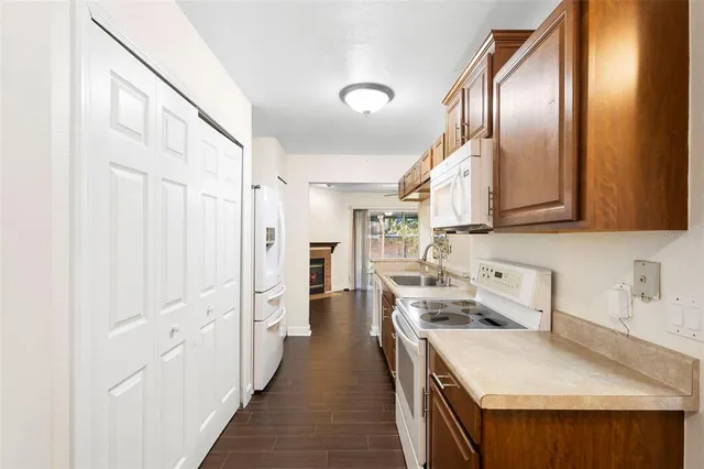 a kitchen with stainless steel appliances a sink and a refrigerator