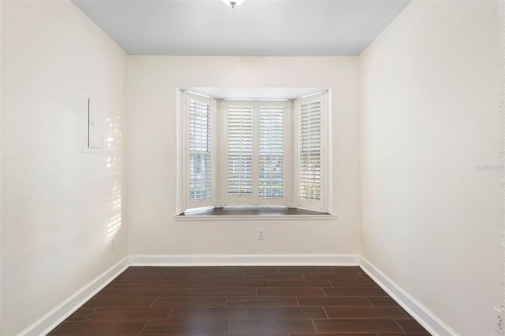 949 Tillery Way, Unit 101 Orlando, FL 32828 - Photo 14 of 38 a view of an empty room with wooden floor and a window