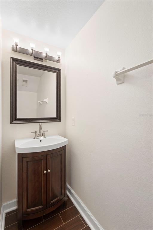 949 Tillery Way, Unit 101 Orlando, FL 32828 - Photo 15 of 38 a bathroom with a sink and a mirror