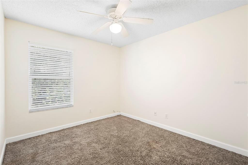 949 Tillery Way, Unit 101 Orlando, FL 32828 - Photo 19 of 38 an empty room with a window and a ceiling fan