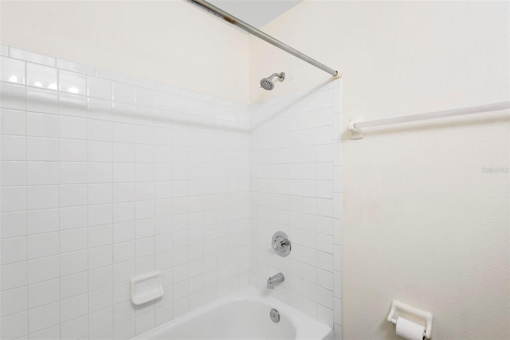 949 Tillery Way, Unit 101 Orlando, FL 32828 - Photo 22 of 38 a bathroom with a shower and a bathtub
