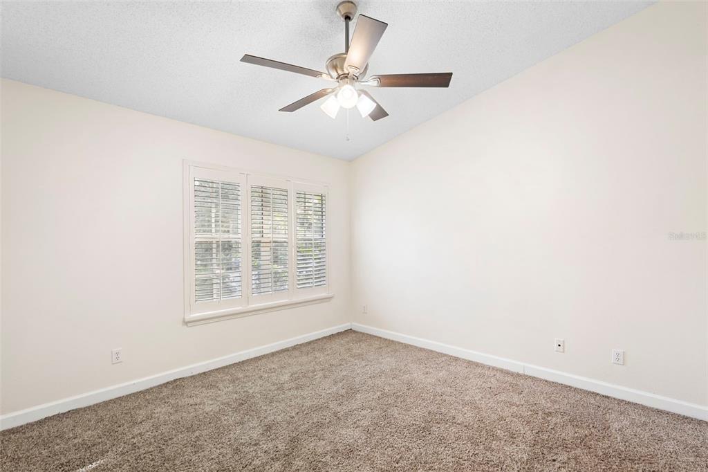 949 Tillery Way, Unit 101 Orlando, FL 32828 - Photo 23 of 38 an empty room with a window and a fan