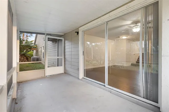a view of empty room with window and ceiling fan