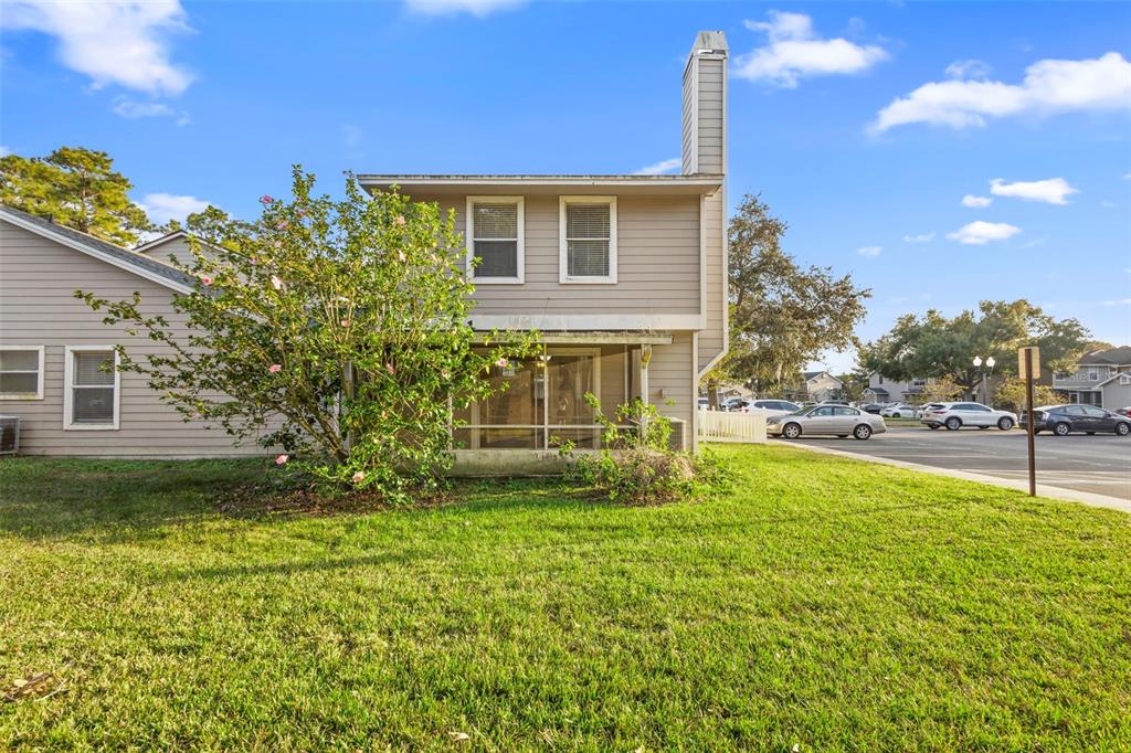 949 Tillery Way, Unit 101 Orlando, FL 32828 - Photo 30 of 38 a view of a house with a yard