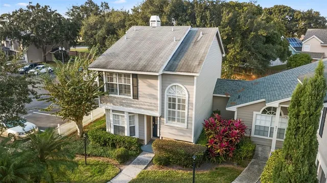 a aerial view of a house with a yard and potted plants