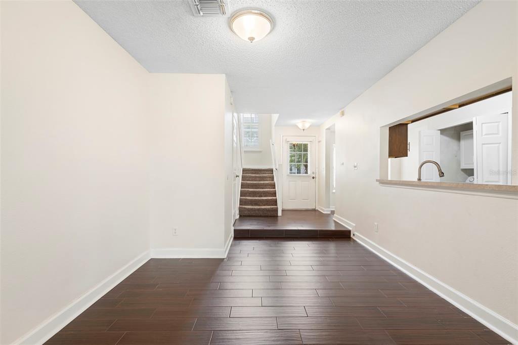 949 Tillery Way, Unit 101 Orlando, FL 32828 - Photo 5 of 38 a view of a hallway with wooden floor