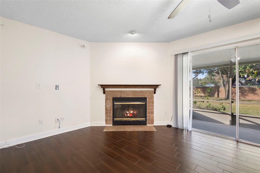 949 Tillery Way, Unit 101 Orlando, FL 32828 - Photo 9 of 38 wooden floor fireplace and natural light in room
