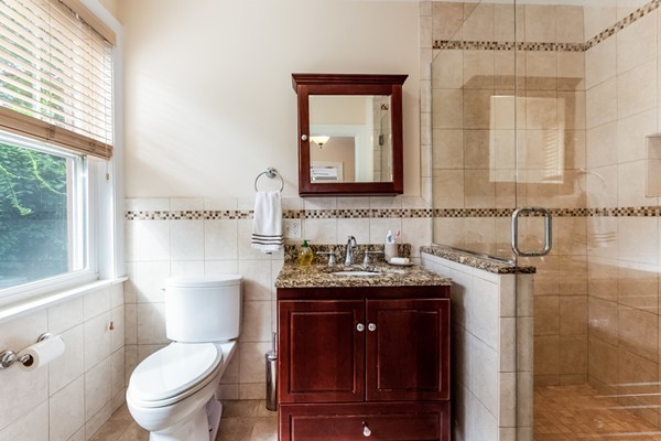 104 Cutter Hill Road Arlington, MA 02474 - Photo 11 of 19 a bathroom with a granite countertop toilet sink and mirror