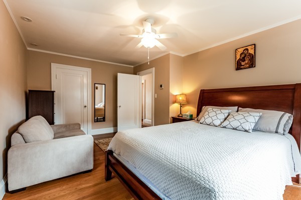 104 Cutter Hill Road Arlington, MA 02474 - Photo 12 of 19 a bedroom with a bed couch and a chandelier
