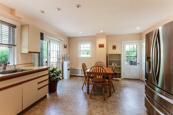 104 Cutter Hill Road Arlington, MA 02474 - Photo 8 of 19 a kitchen with sink refrigerator dining table and chairs