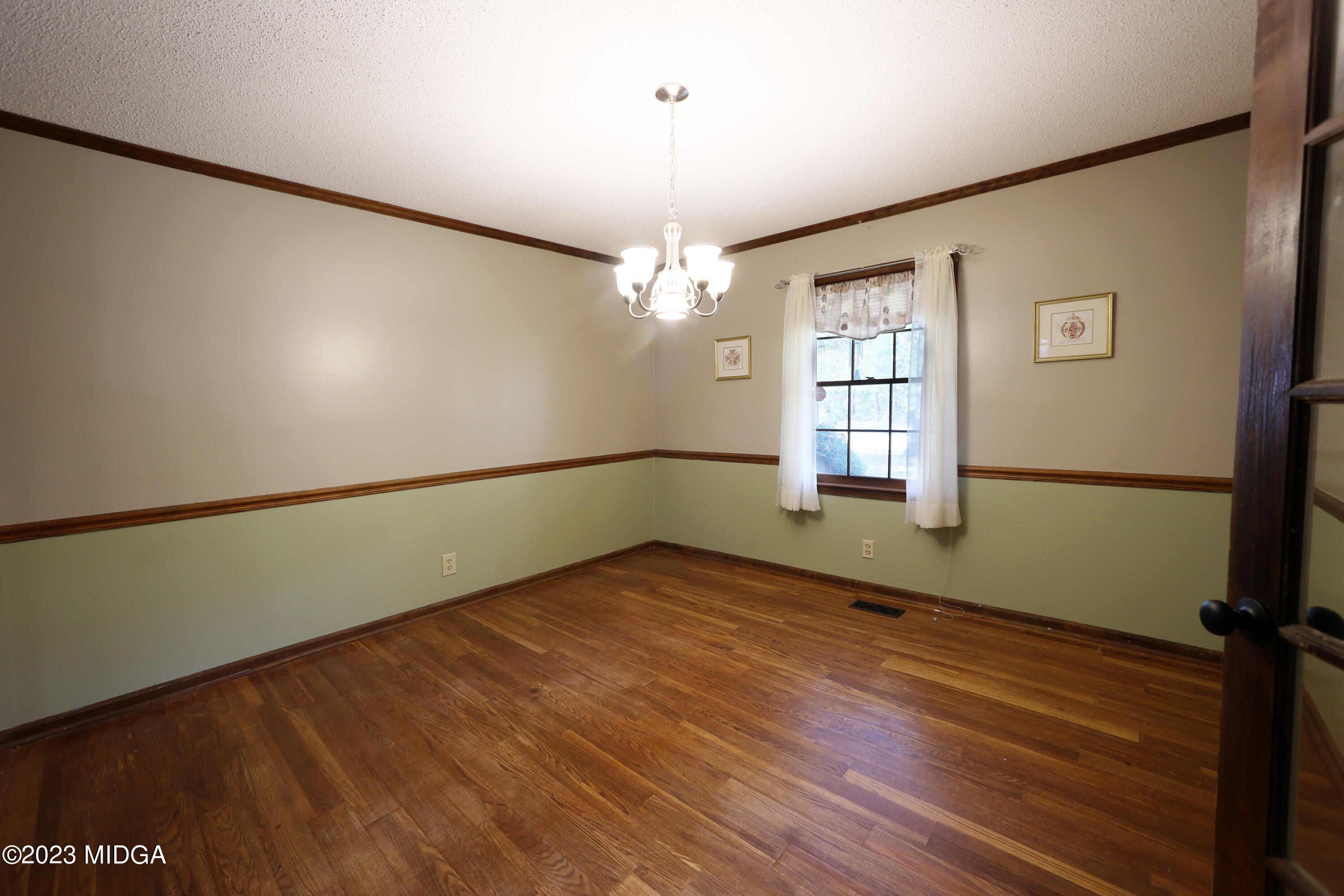 5740 Huddersfield Road Macon, GA 31210 - Photo 12 of 36 a view of an empty room with window and wooden floor