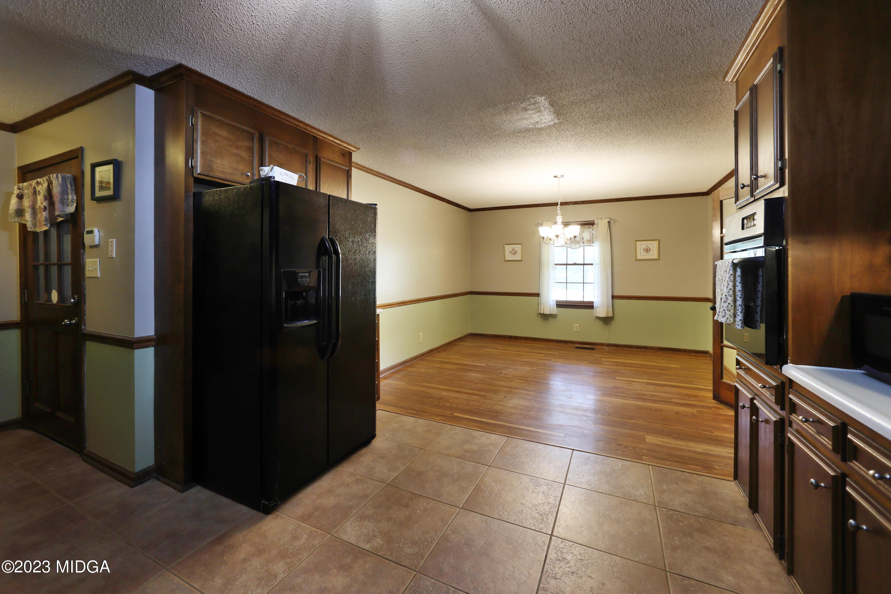 5740 Huddersfield Road Macon, GA 31210 - Photo 14 of 36 a view of a refrigerator in kitchen and an empty room