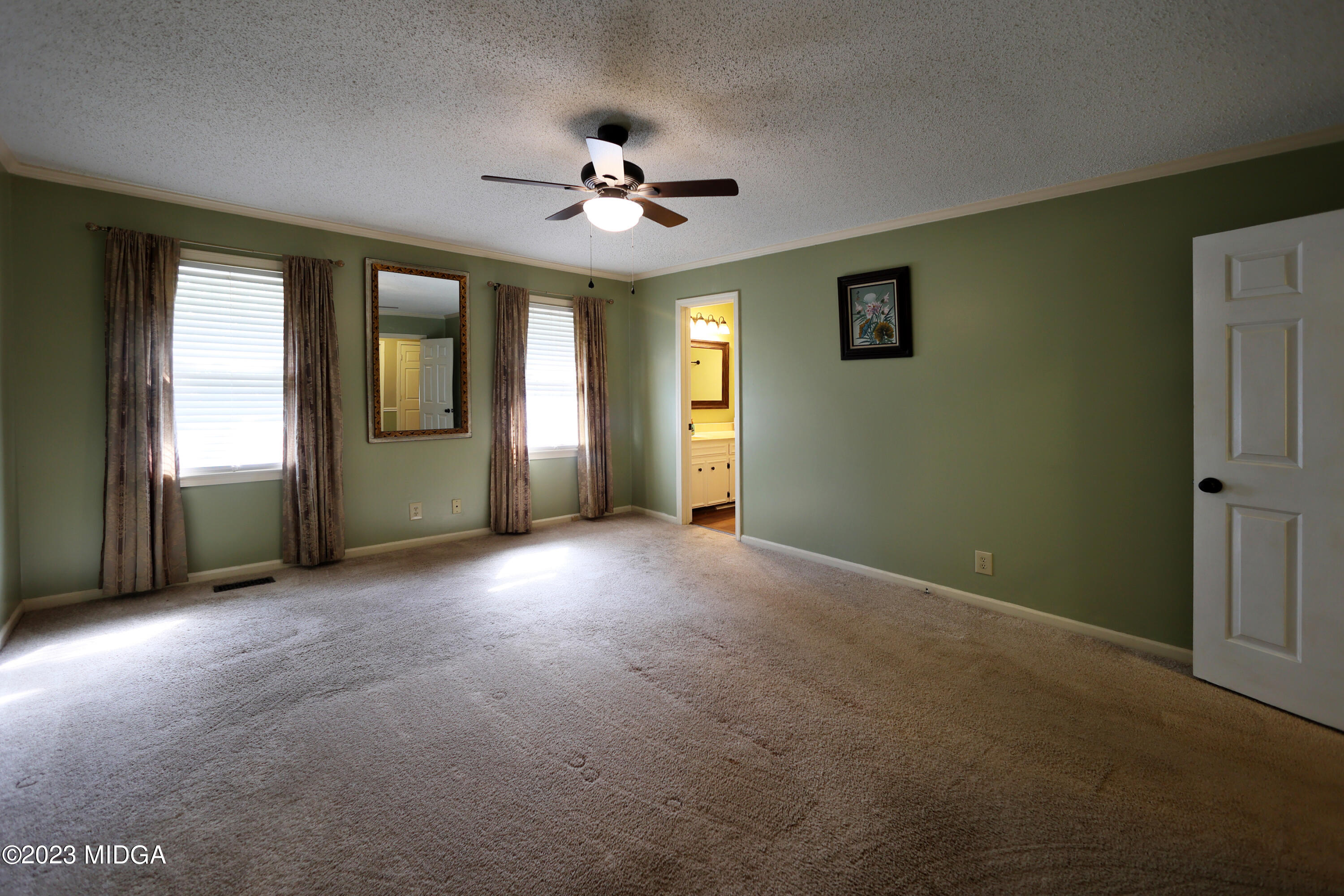 5740 Huddersfield Road Macon, GA 31210 - Photo 19 of 36 a view of a livingroom with a chandelier fan and windows