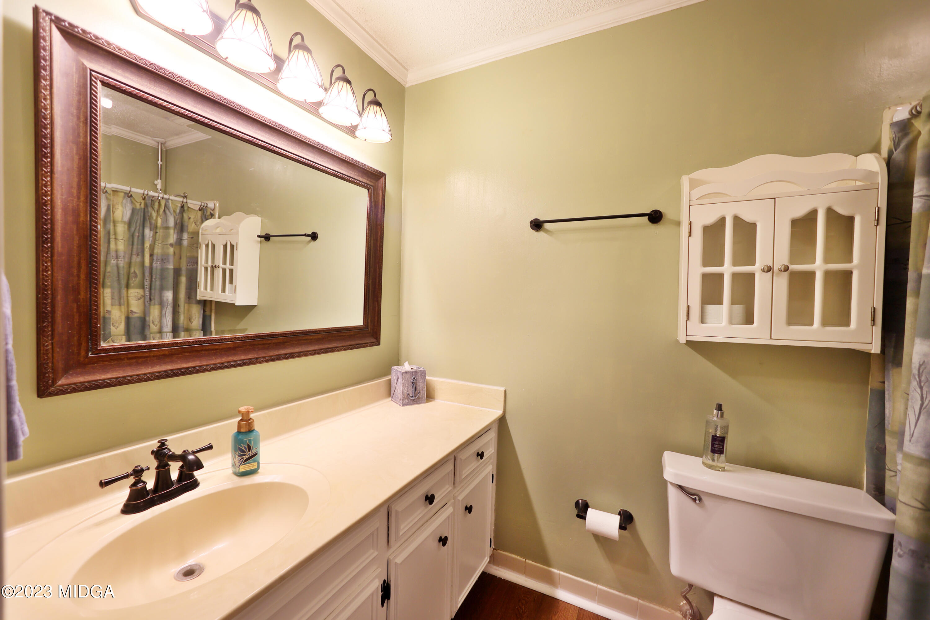 5740 Huddersfield Road Macon, GA 31210 - Photo 21 of 36 a bathroom with a sink vanity and a mirror