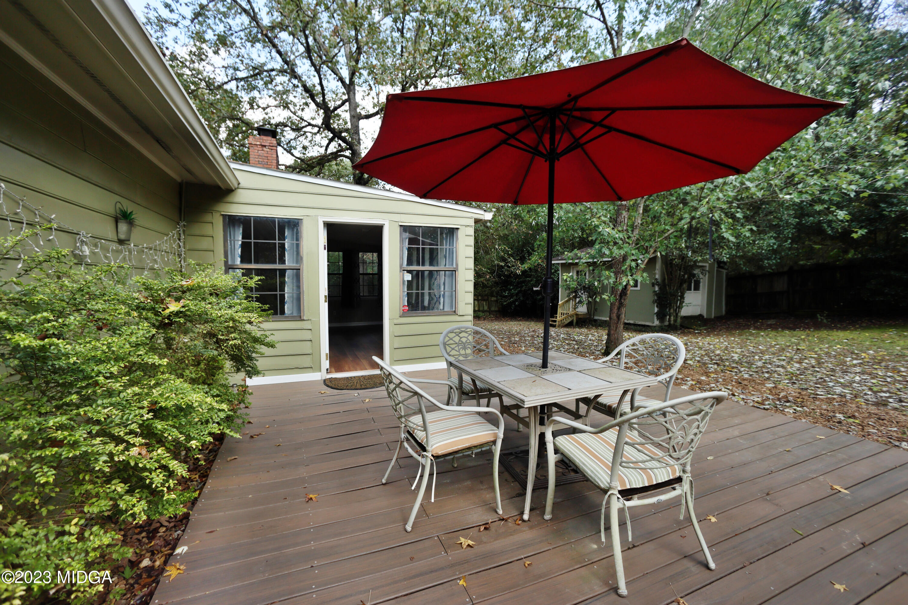 5740 Huddersfield Road Macon, GA 31210 - Photo 30 of 36 a patio with a table and chairs under an umbrella