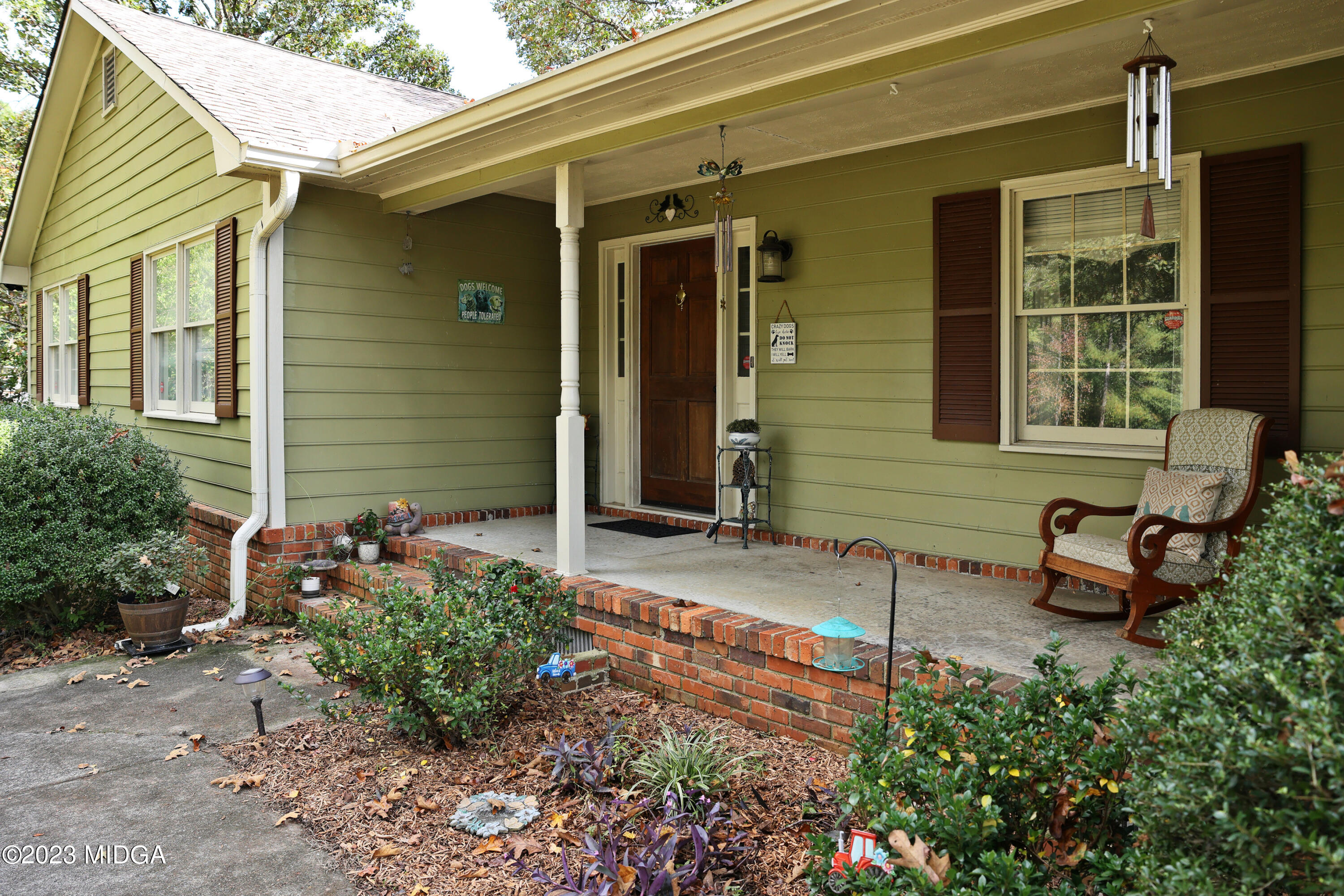 5740 Huddersfield Road Macon, GA 31210 - Photo 4 of 36 a front view of a house with outdoor seating and trees