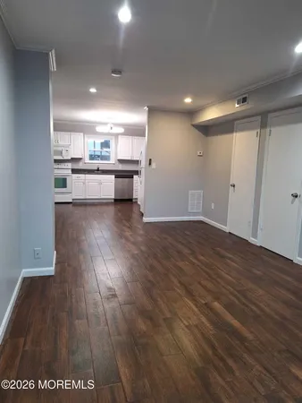 a view of kitchen with cabinets and wooden floor