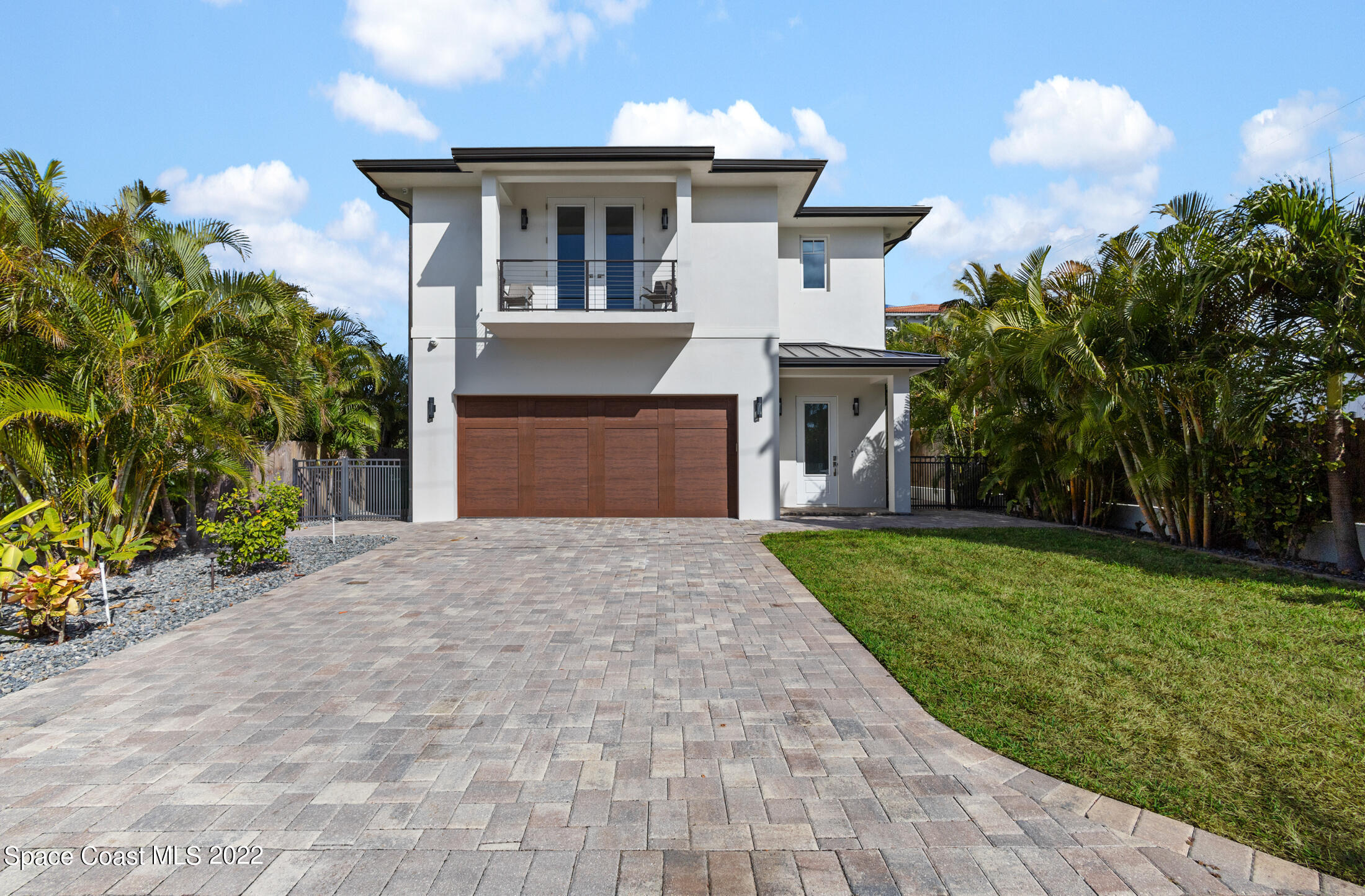 a front view of a house with a yard and a garage