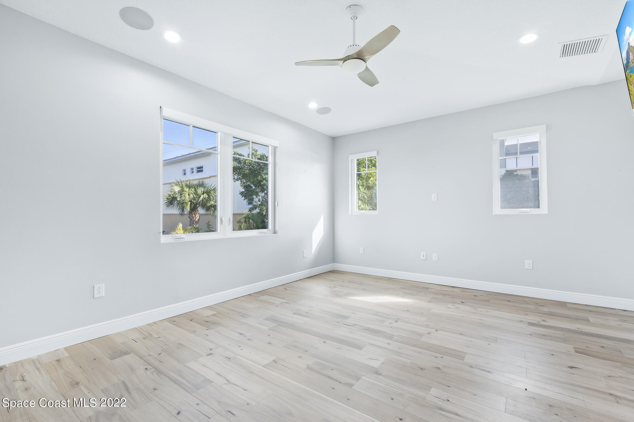 151 24th Street Cocoa Beach, FL 32931 - Photo 19 of 36 wooden floor in an empty room with a window