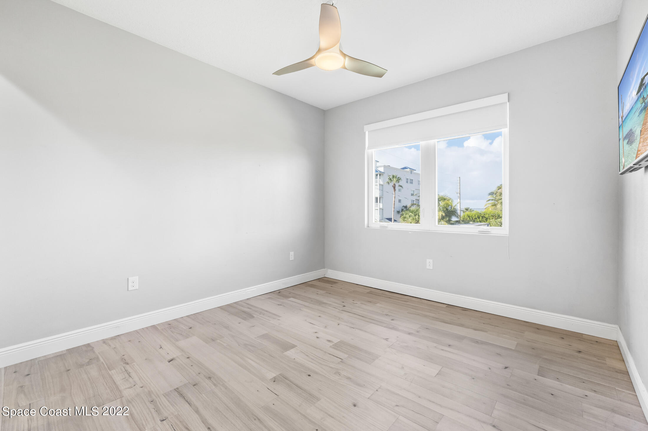 151 24th Street Cocoa Beach, FL 32931 - Photo 26 of 36 wooden floor in an empty room with a window