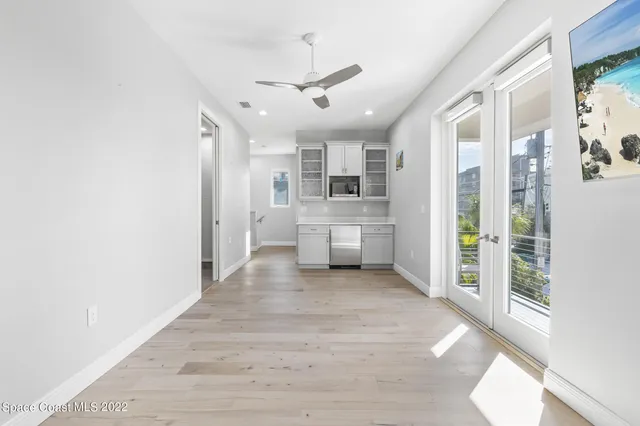 a view of a kitchen with a sink and a refrigerator