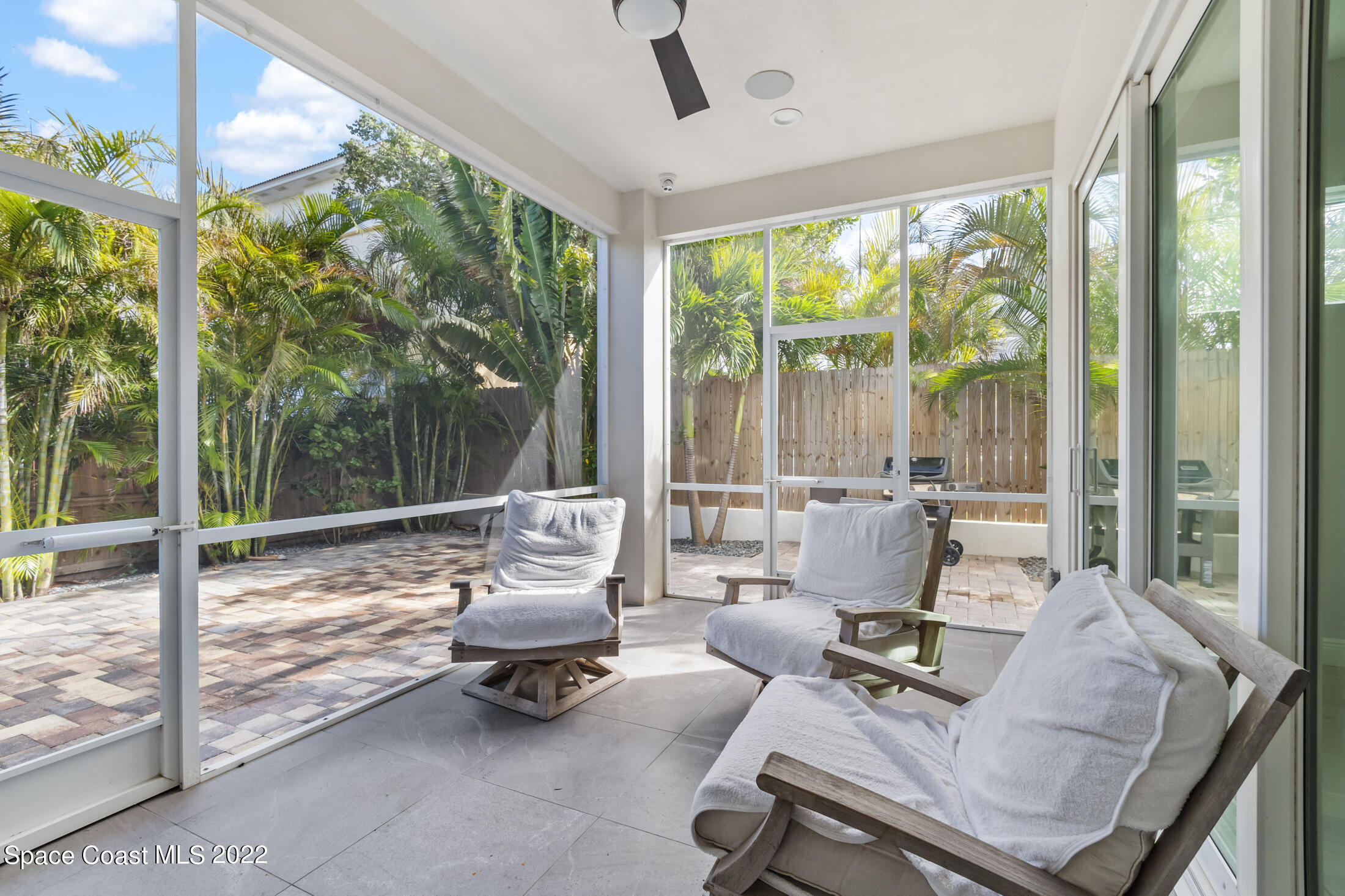 151 24th Street Cocoa Beach, FL 32931 - Photo 33 of 36 a living room with patio furniture and a floor to ceiling window