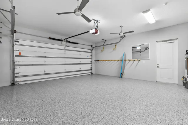 a front view of house with yard and trees in the background