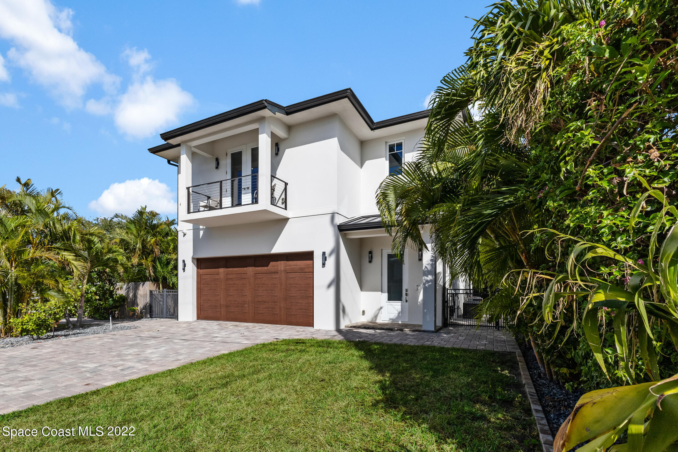 151 24th Street Cocoa Beach, FL 32931 - Photo 36 of 36 a front view of house with yard and trees in the background