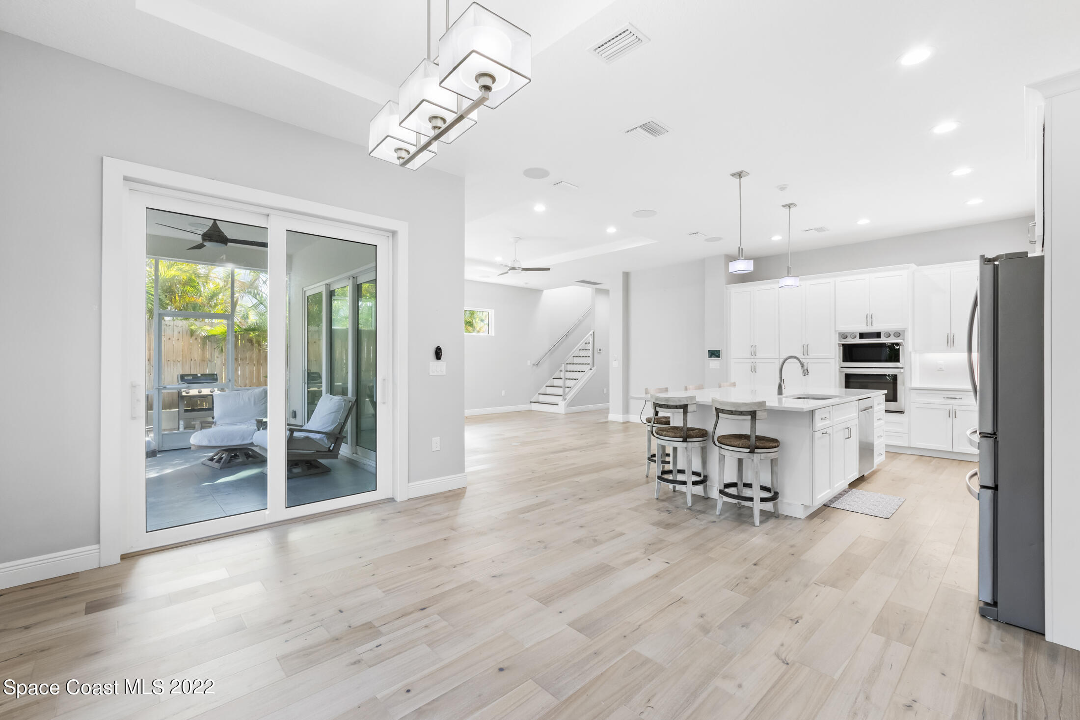 151 24th Street Cocoa Beach, FL 32931 - Photo 7 of 36 a view of a kitchen with dining table and chairs