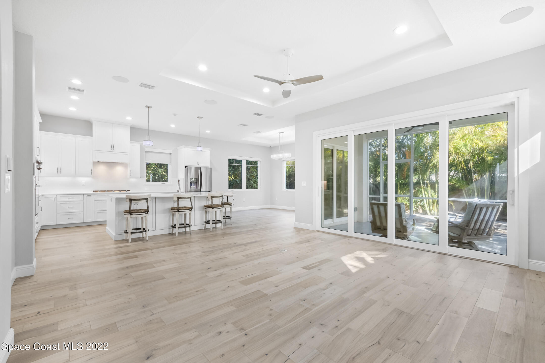 151 24th Street Cocoa Beach, FL 32931 - Photo 8 of 36 a room with lots of table chair and a large window