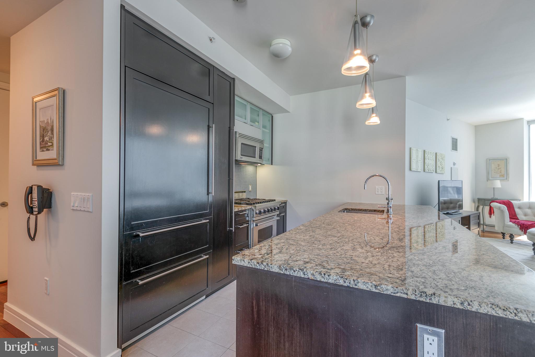 1414 South Penn Square, Unit 16A Philadelphia, PA 19102 - Photo 11 of 34 a kitchen with granite countertop a refrigerator and a sink