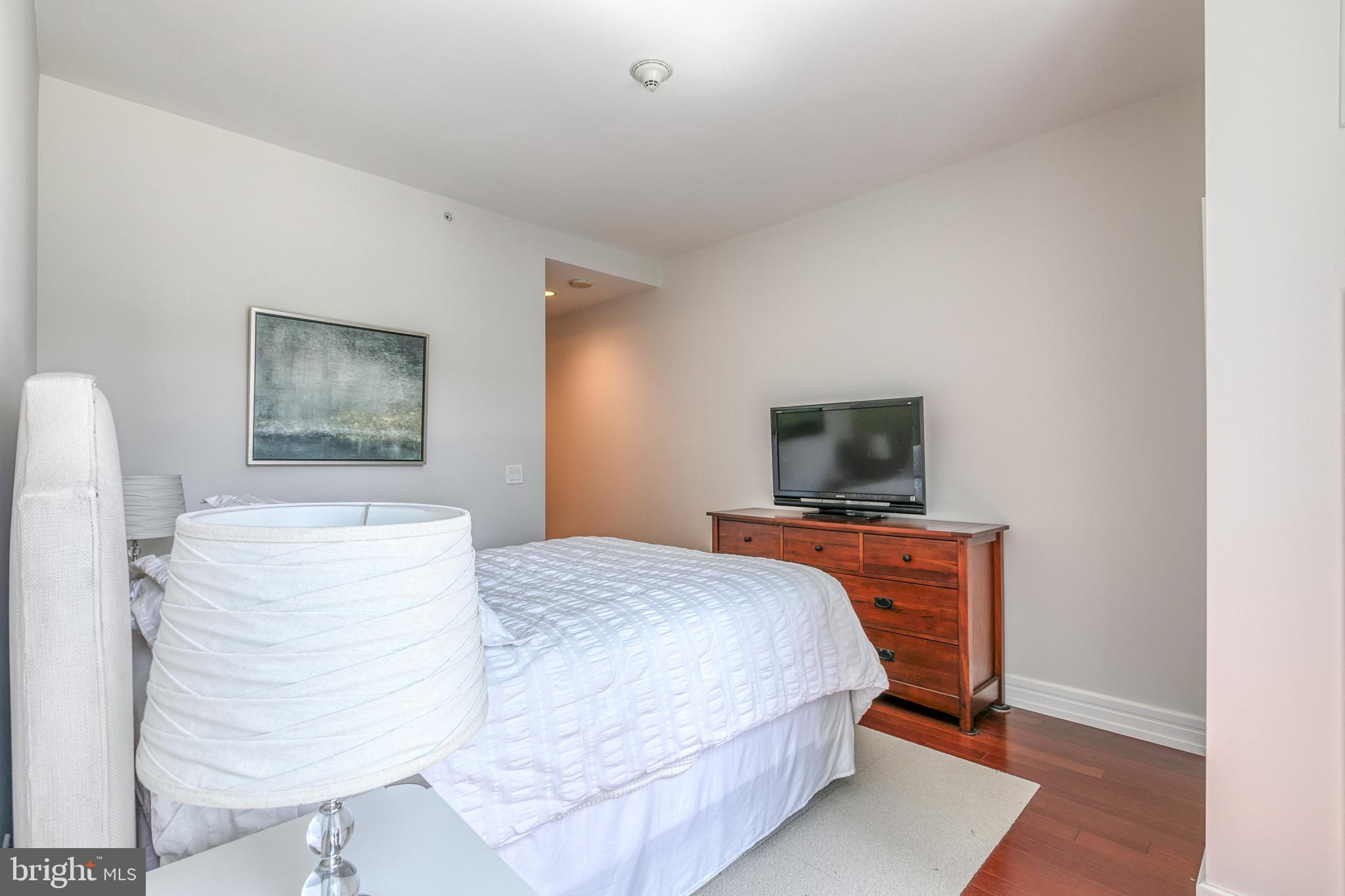 1414 South Penn Square, Unit 16A Philadelphia, PA 19102 - Photo 14 of 34 a bedroom with a bed and a flat screen tv