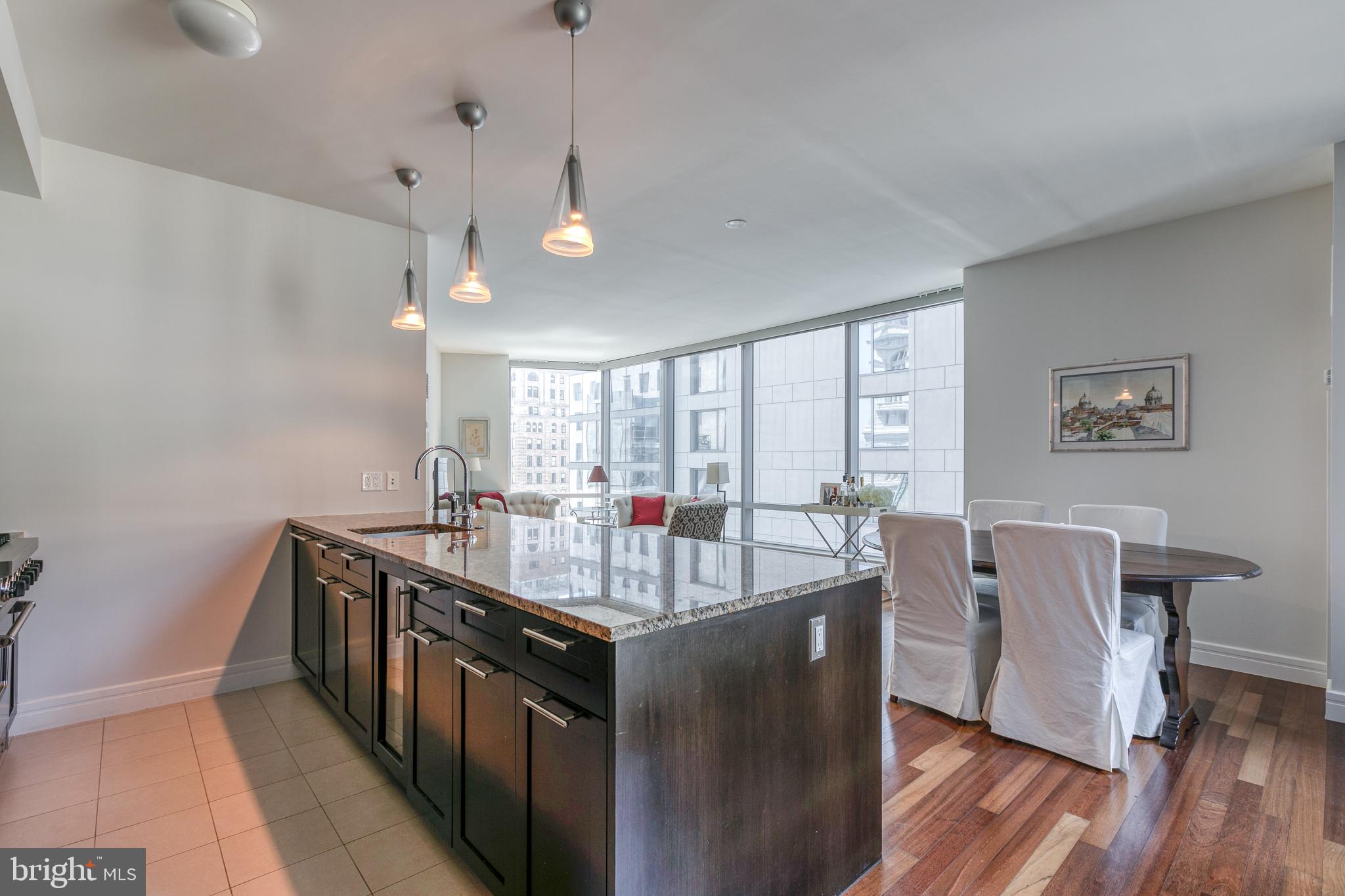 1414 South Penn Square, Unit 16A Philadelphia, PA 19102 - Photo 8 of 34 a kitchen with stainless steel appliances granite countertop a sink a stove and wooden floor