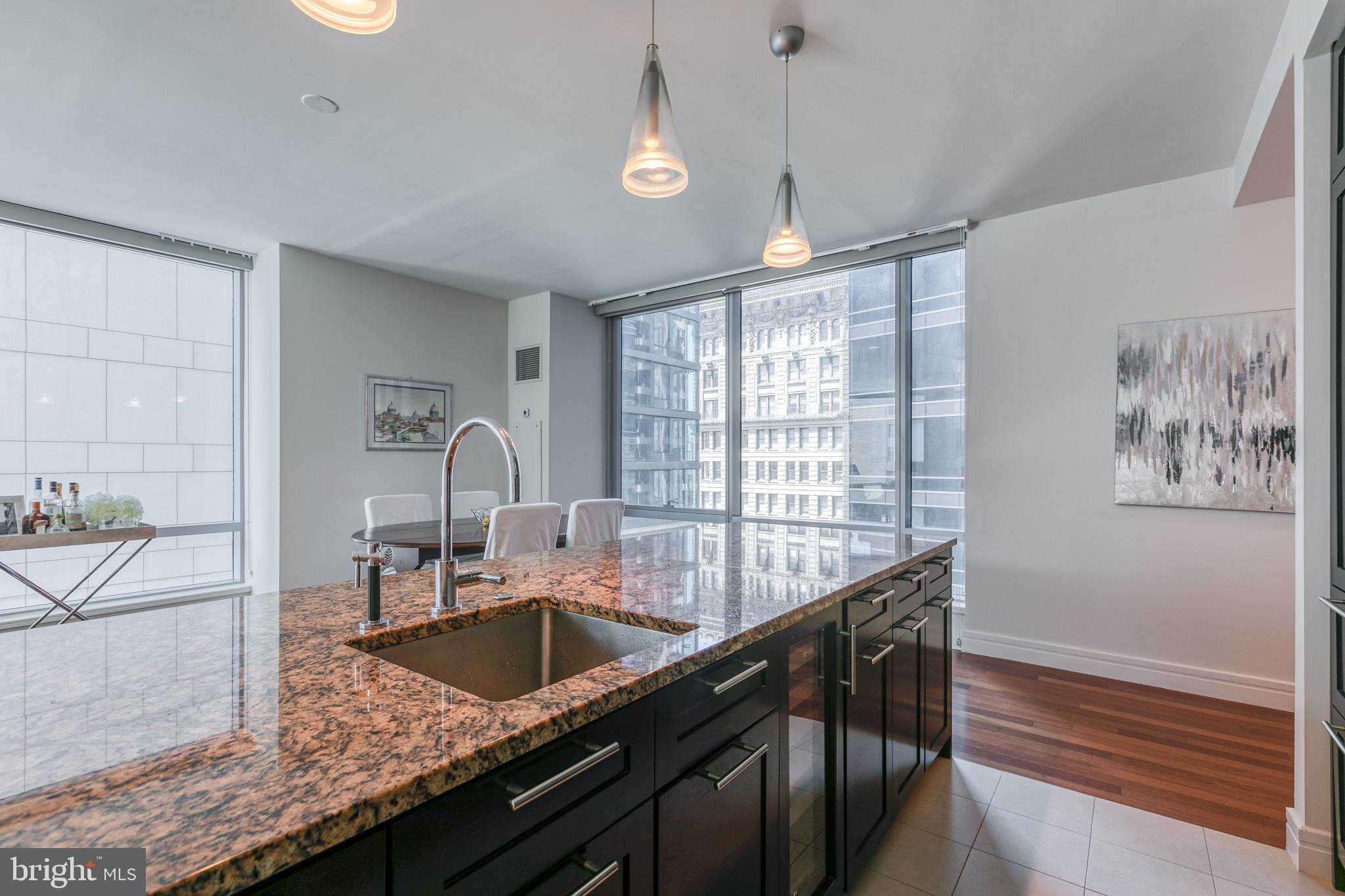 1414 South Penn Square, Unit 16A Philadelphia, PA 19102 - Photo 9 of 34 a kitchen with granite countertop a sink and a window