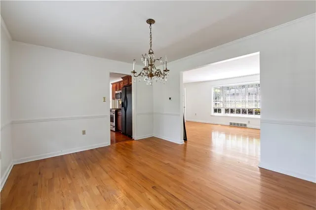 a view of a room with window and wooden floor