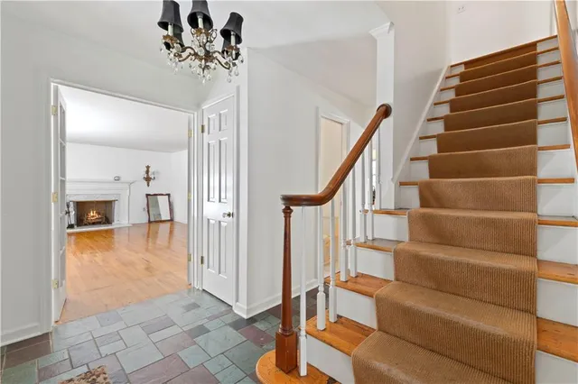 a view of entryway and hall with wooden floor