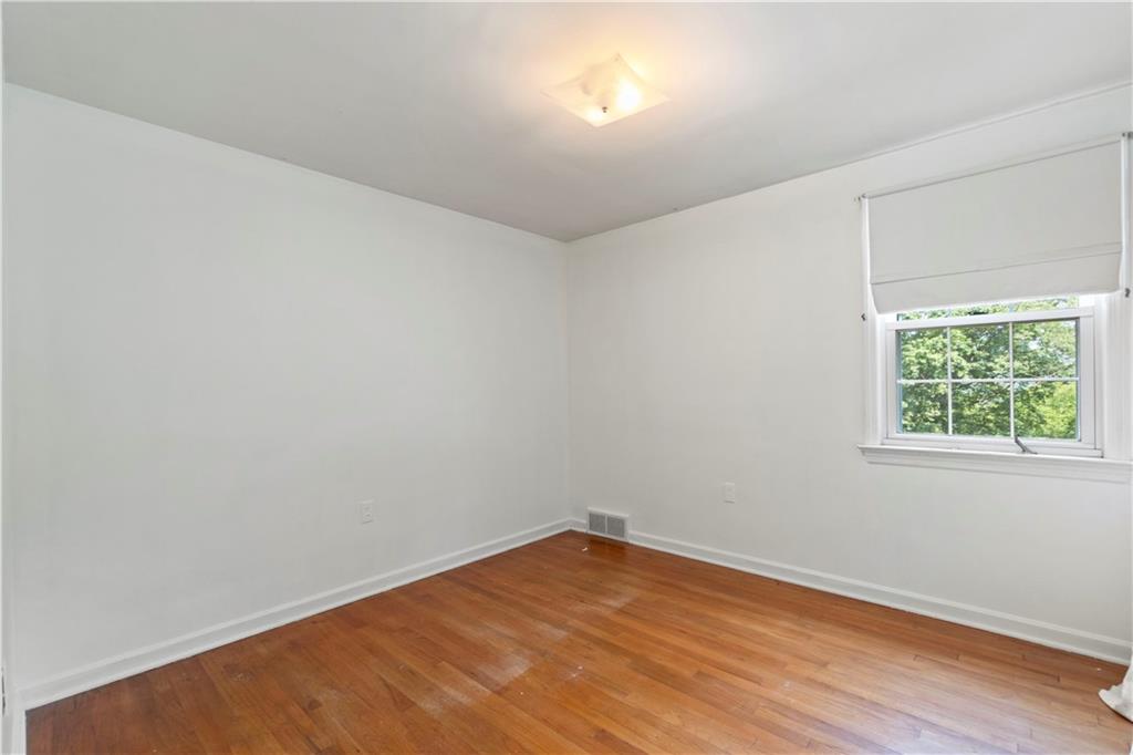 24 Oakglen Drive Oakmont, PA 15139 - Photo 24 of 50 wooden floor in an empty room with a window