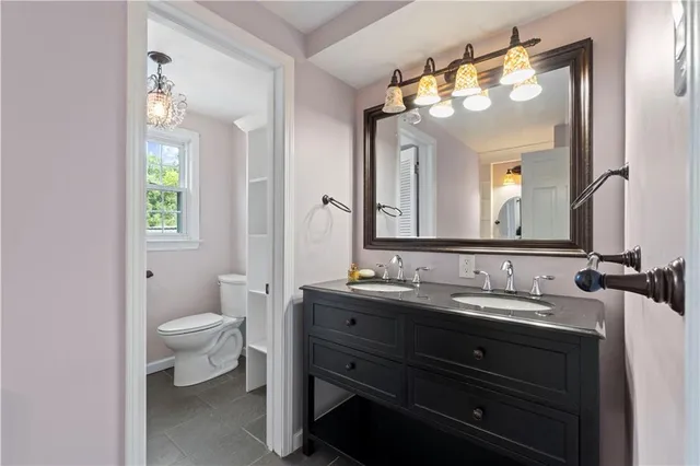 a bathroom with a double vanity sink and a mirror