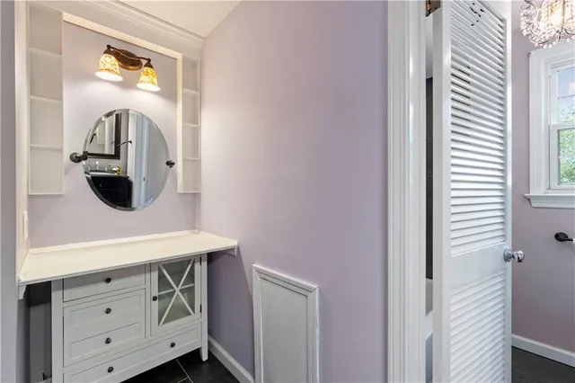 a room with a sink and a mirror