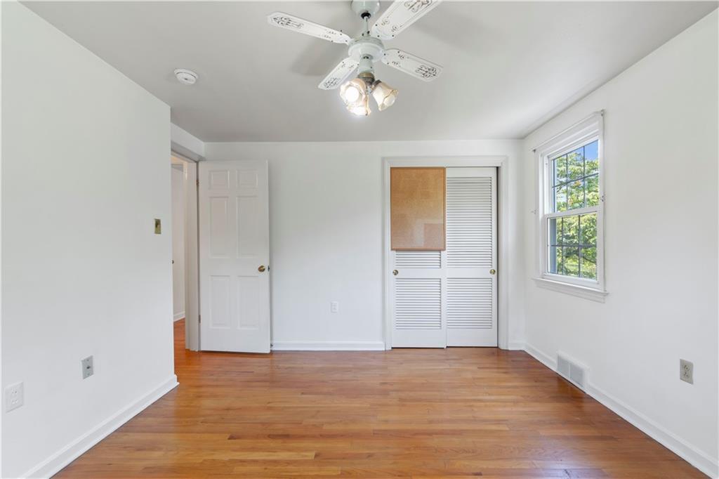24 Oakglen Drive Oakmont, PA 15139 - Photo 31 of 50 wooden floor in an empty room with a window