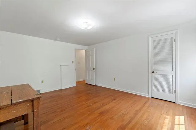 a view of a room with wooden floor