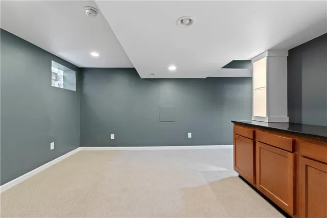a view of kitchen with stainless steel appliances granite countertop cabinets and sink